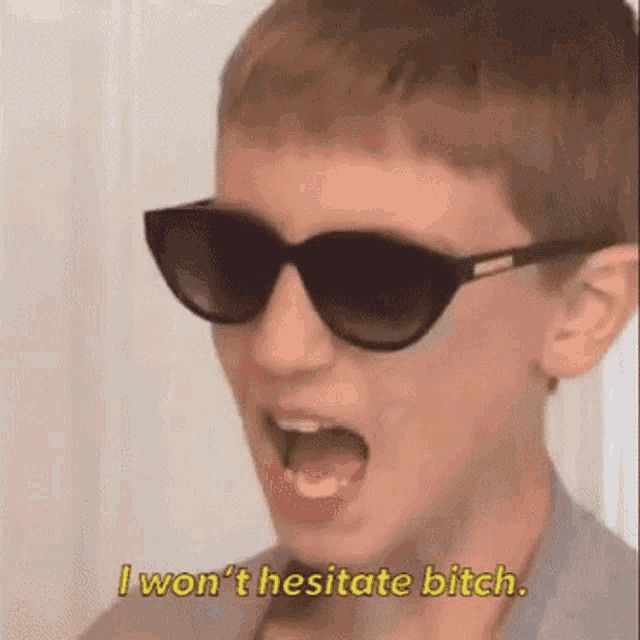 a young boy wearing sunglasses is screaming and says `` i won 't hesitate bitch '' .