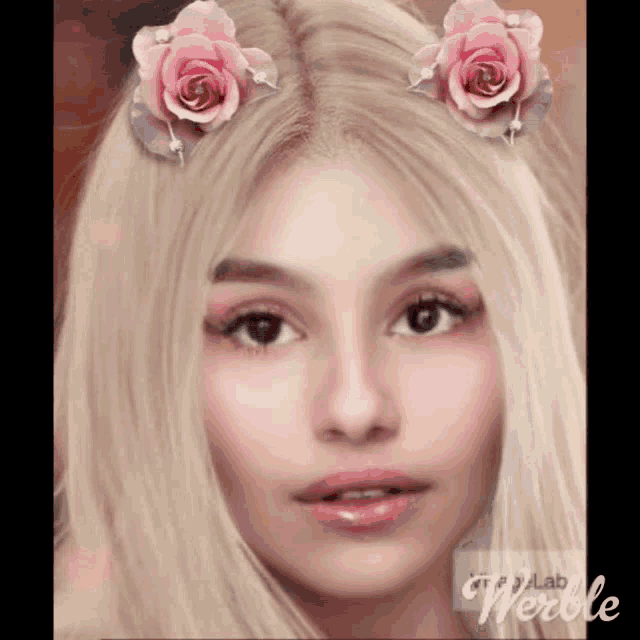a close up of a woman 's face with pink flowers in her hair