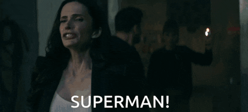 a woman in a dark room says superman
