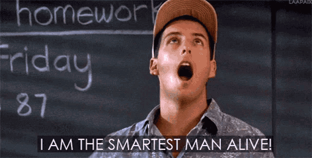 a man is standing in front of a blackboard and says i am the smartest man alive .