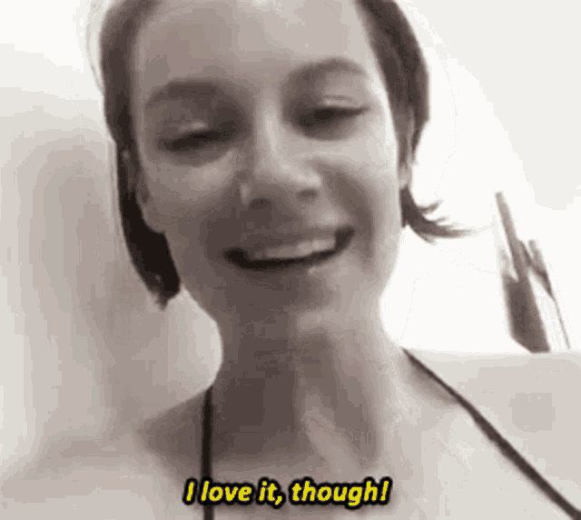 a woman in a bikini is smiling and says i love it though