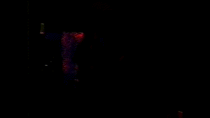 a man is playing a guitar in a red lighted room .