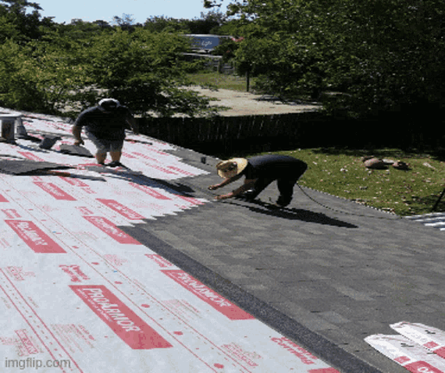 two men are working on a roof with a roofing material that says proguard