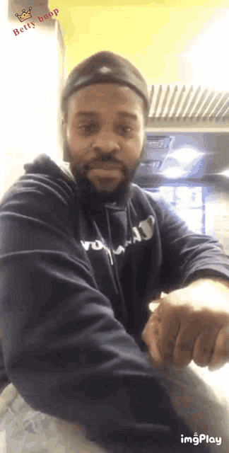 a man with a beard is wearing a hoodie that says ' wo ' on it