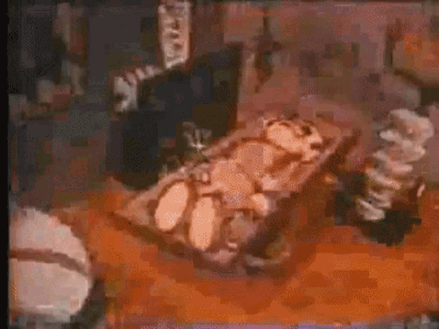 a painting of a person laying on a table with a few pieces of meat on it