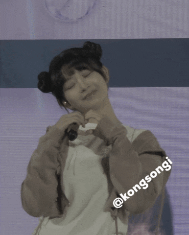 a girl holding a microphone with the name kongsongi on the bottom right