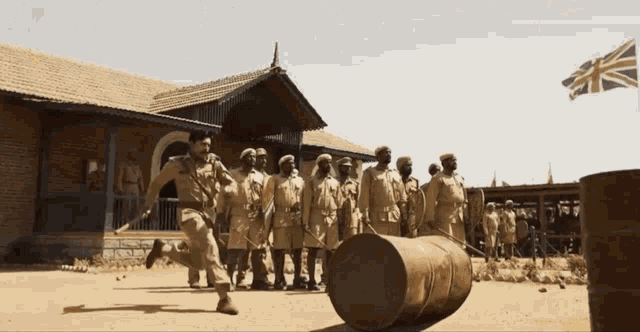 a group of soldiers standing around a large barrel