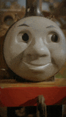 a close up of thomas the train 's face with a smile on it 's face