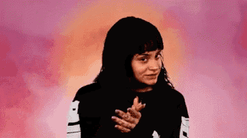 a woman in a black shirt is making a funny face .