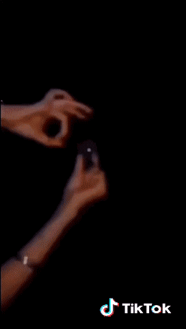a tiktok video shows a person holding a sparkler in their hand