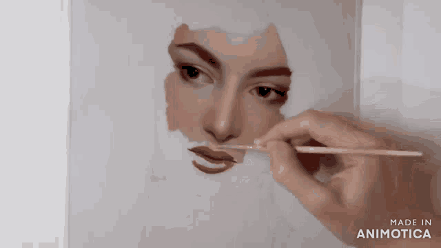a person is painting a woman 's face with a brush and the words made in animatica are visible