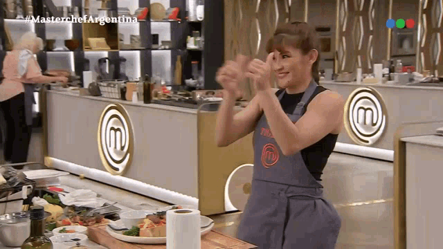 a woman wearing an apron that says masterchef argentina