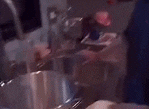 a young man is pouring something into a pot in a kitchen