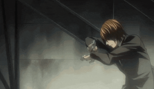 a man in a suit is holding a gun in his hand