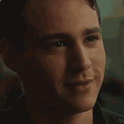 a close up of a man 's face smiling with his mouth open .