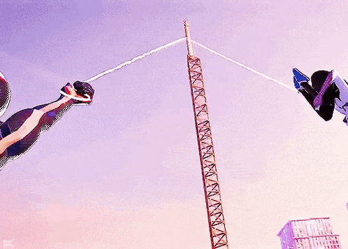 a man in a spiderman suit is flying through the air