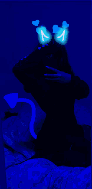 a person is taking a picture of themselves in a dark room with blue lights behind them