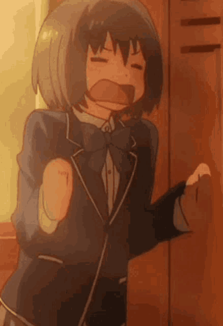 a girl in a school uniform is standing in front of a locker with her mouth open .