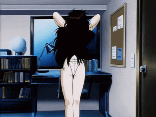 a naked woman stands in front of a desk in a room with a bulletin board