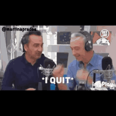two men wearing headphones are sitting in front of microphones in a radio station .
