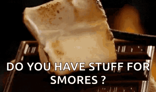 a piece of s'mores is sitting on top of a piece of chocolate ..