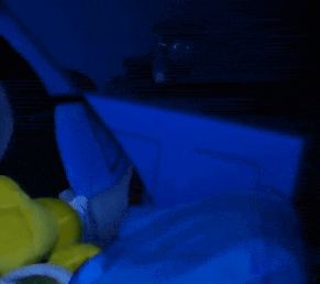 a person is laying in a bed with a blue blanket