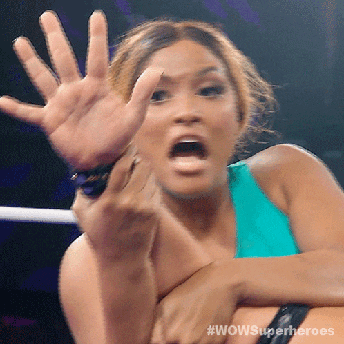 a woman in a wrestling ring with wow superheroes written on the bottom