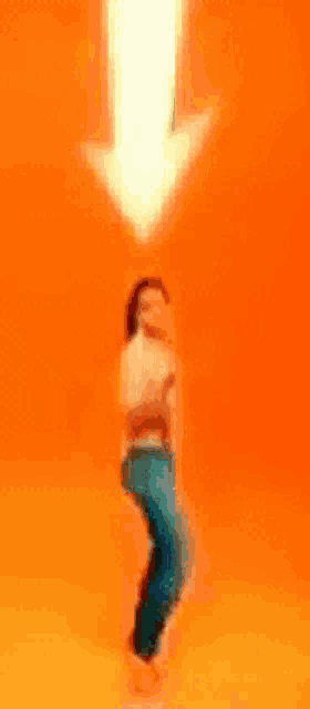 a woman is dancing in front of an orange background with an arrow pointing up .
