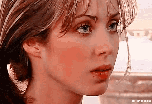 a close up of a woman 's face with the words edits portiranoni visible