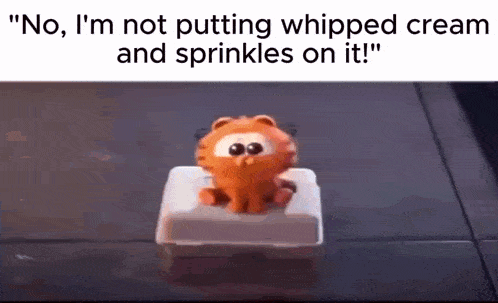 garfield is sitting on a button with whipped cream and sprinkles on it