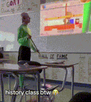 a man in a green shirt is standing in front of a white board that says hall of fame on it