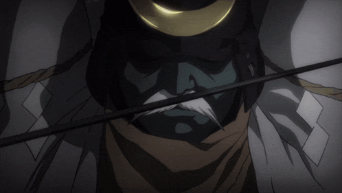 a close up of a person holding a sword in the dark