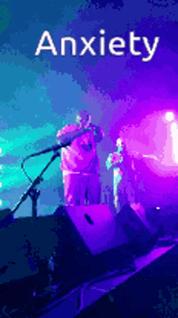 a man singing into a microphone with the word anxiety written above him