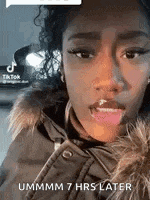 a woman in a fur coat is making a funny face with her tongue hanging out .