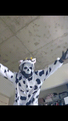 a person dressed in a cow costume with a skull on it