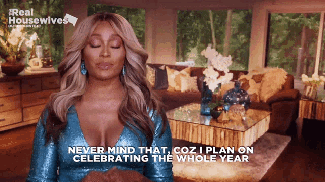 a woman in a blue sequined dress says never mind that coz i plan on celebrating the whole year