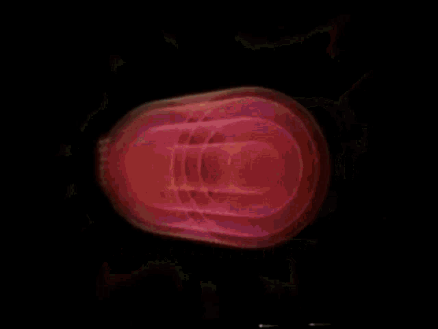 a close up of a pink object with lightning bolts coming out of it .