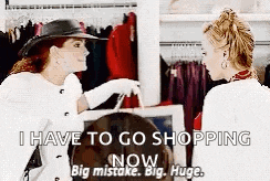 two women are standing next to each other in a clothing store talking about shopping .