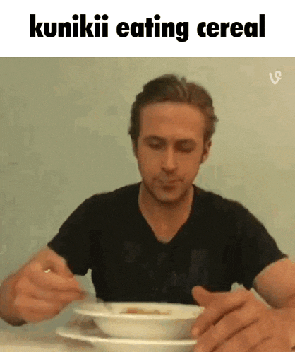 a man is sitting at a table eating cereal with the caption " kunikii eating cereal "