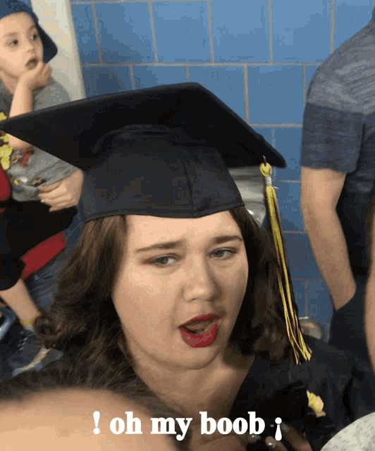 a woman in a graduation cap and gown says oh my boob i