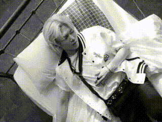 a black and white photo of a man laying in a bed