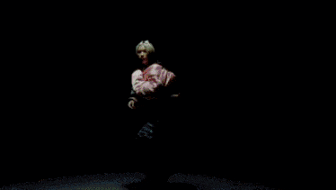 a close up of a woman 's blonde hair against a black background