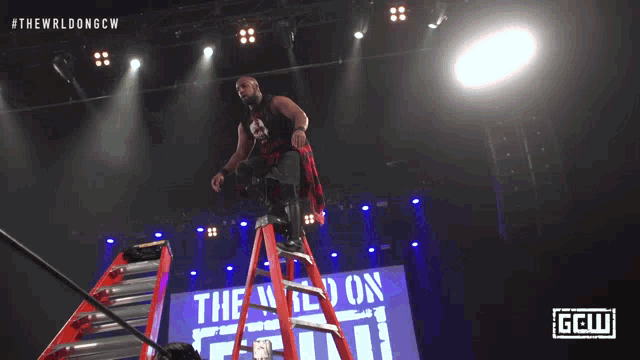 a man is falling off a ladder in a wrestling match