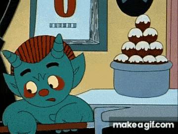 a cartoon monster is sitting in front of a bowl of donuts .