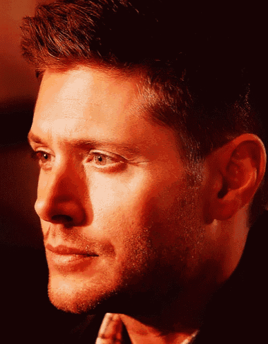 a close up of a man 's face with a red background