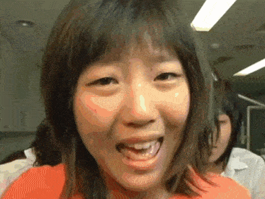 a close up of a young woman 's face with her mouth open