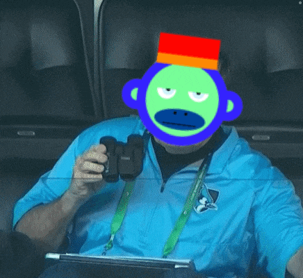 a man wearing a blue shirt and a green monkey mask