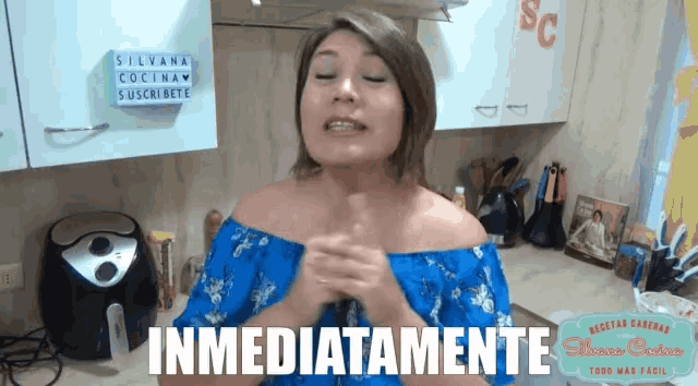 a woman in a blue off the shoulder top says " inmediatamente "