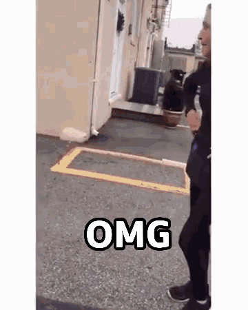 a man is walking down the street with a bottle of water in his hand and a sign that says omg .