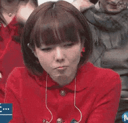 a woman in a red shirt with the letter m on the bottom right